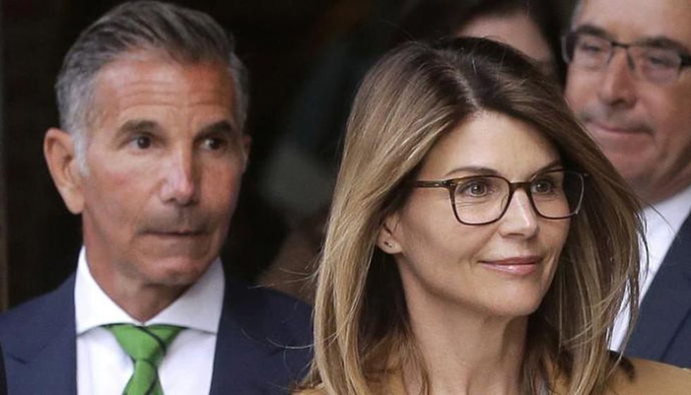 FILE - In this April 3, 2019, file photo, actress Lori Loughlin, front, and her husband,...