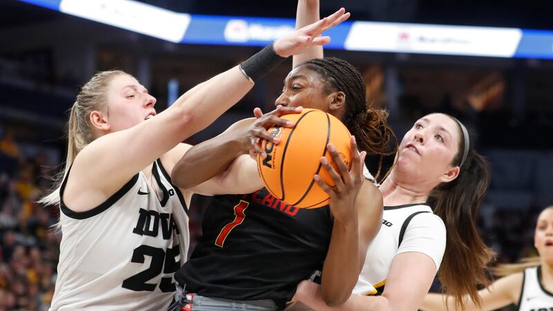 Maryland guard Diamond Miller (1) tries to compete between Iowa forward Monika Czinano, left,...