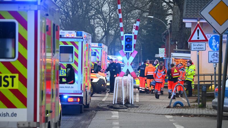 Police and rescue services are on duty at a level crossing near Brokstedt station in...