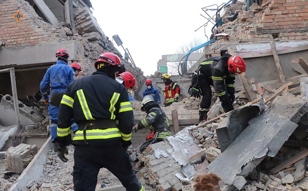 In this photo provided by the Ukrainian Emergency Service, emergency personnel work at the...