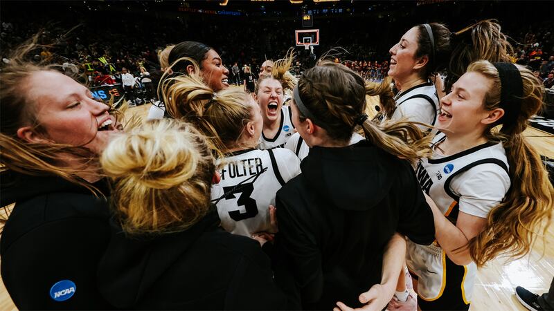The Iowa women's basketball team celebrates a win in the NCAA tournament regional final on...