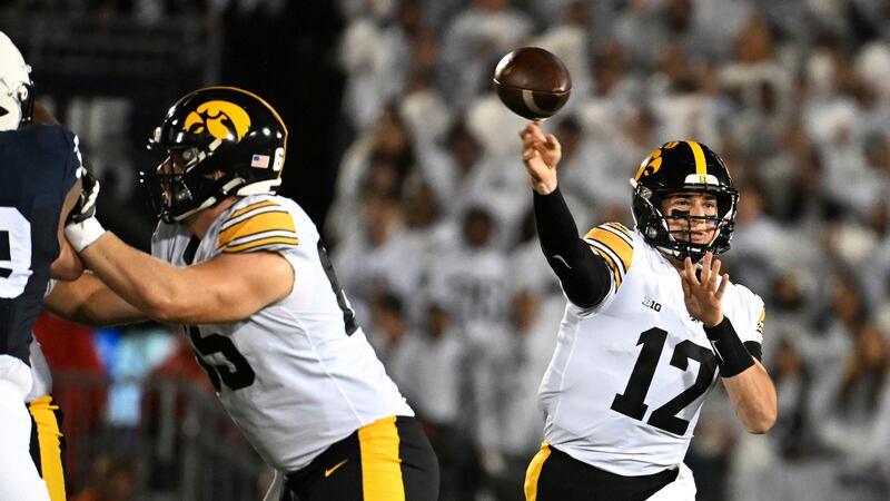Iowa quarterback Cade McNamara (12) looks to pass against Penn State during the first half of...