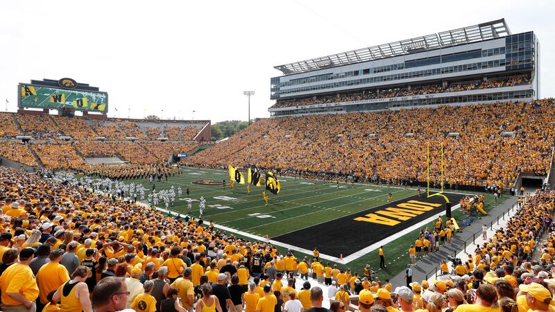 FILE - Fans cheer before an NCAA college football game between Iowa and North Texas at Kinnick...